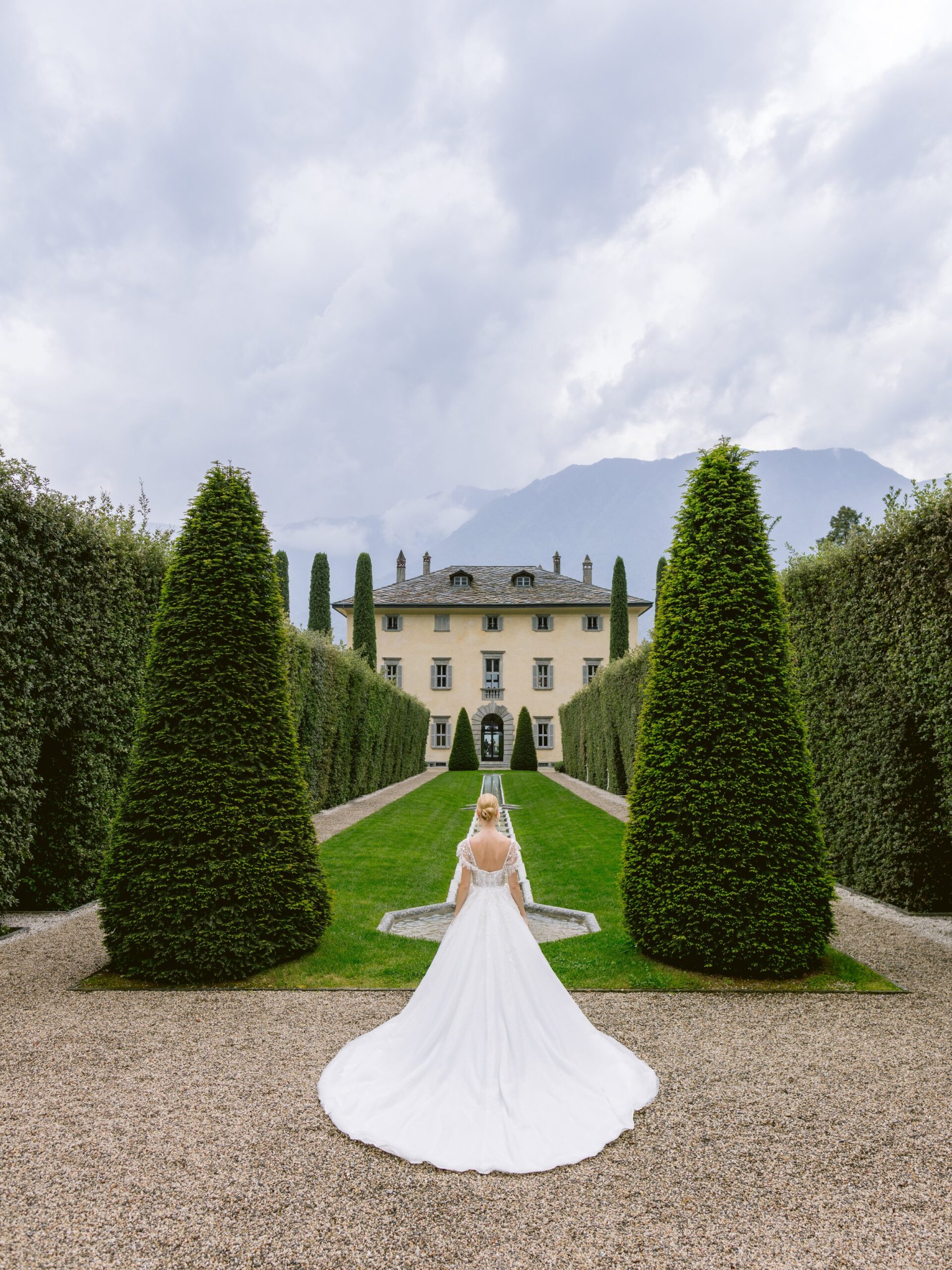 How to Elope in Italy Villa Balbiano Bride Looking at Venue Showcasing back of the dress