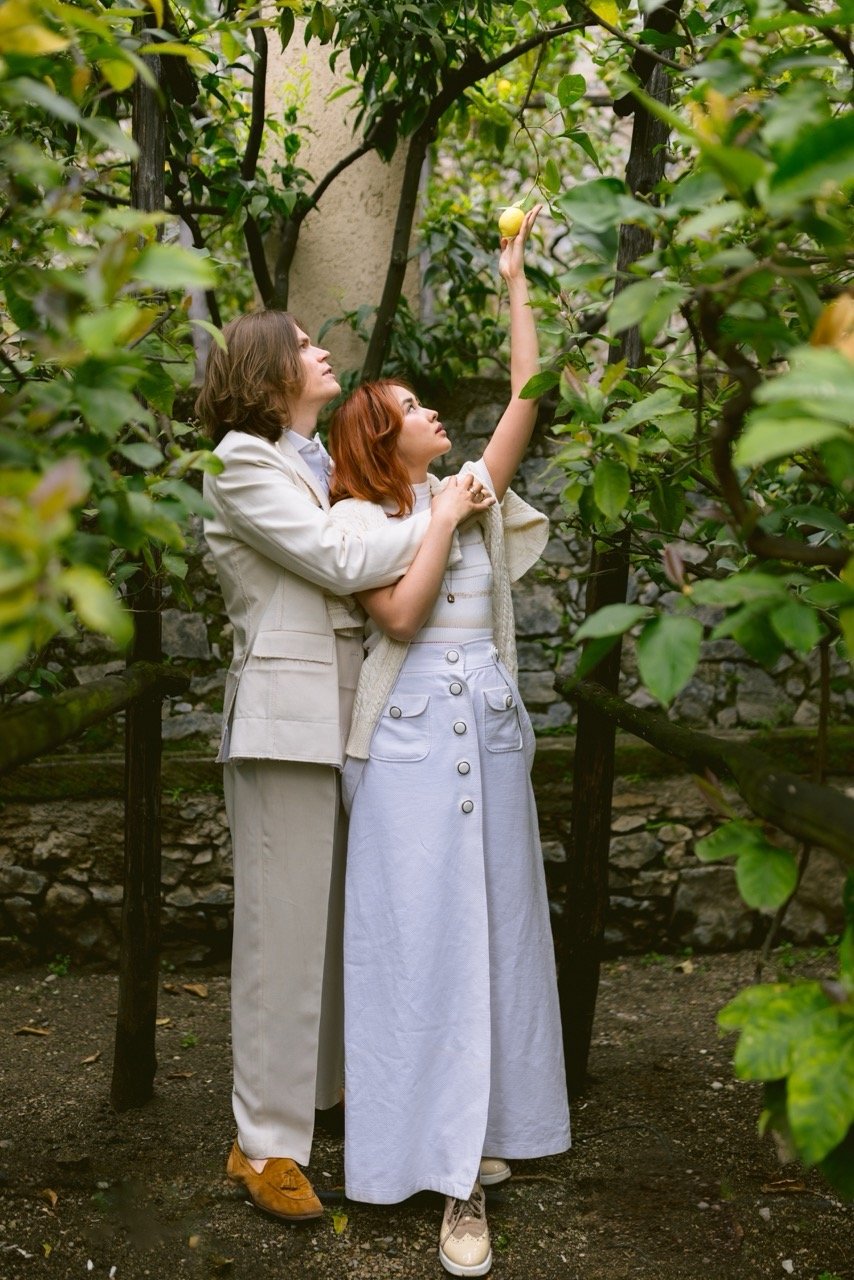 How to Elope in Italy at a Lemon Grove on Lake Garda Elopement Couple picking a lemon