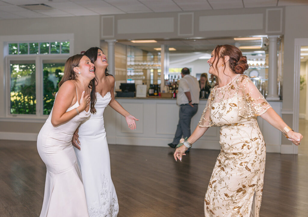 bride and sister dance with mom tirrell room wedding photo