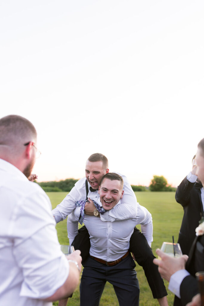 groomsmen having fun cocktail hour tirrell room wedding 