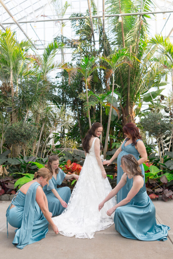 roger williams botanical garden wedding party portrait fixing brides dress